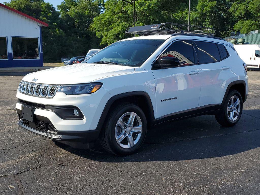 2023 Bright White Clearcoat /BLACK Jeep Compass Latitude (3C4NJDBNXPT) with an 2.0L L4 DOHC 16V TURBO engine, 8-speed automatic transmission, located at 6064 Gull Rd, Kalamazoo, MI, 49048, (269) 222-0088, 42.328388, -85.512924 - Experience the perfect blend of style, performance, and technology with this pre-owned 2023 Jeep Compass Latitude. Equipped with a robust 4-cylinder, 2.0L engine and advanced 4WD capabilities, this vehicle is ready to tackle both city streets and off-road adventures with confidence. The Jeep Compass - Photo#1